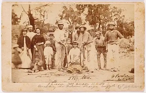 Miners and their wives posing with the finders of the nugget, Richard Oates, John Deason and his wife. The Welcome Stranger Nugget was discovered on 5 February 1869. photograph : albumen silver carte-de-visite ; on mount 6.5 x 10.7 cm. approx.