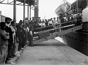 men unboarding a passenger ship