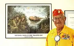 Navajo code talker veteran Thomas Begay with a framed picture commemorating National Navajo Code Talkers Day