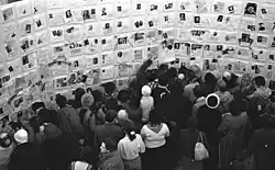 Image of people standing next to the Wall of Sorrow on the victims of the Stalin's Gulag at the first exhibition in the USSR about the crimes of Stalinism