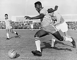 Pelé dribbling past a defender during Malmö-Brazil 1-7