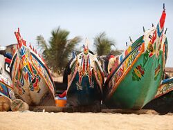 The painted decorative bows of three fishing boats, Gambia