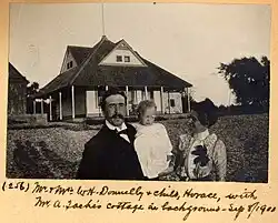 Mr. and Mrs. W. H. Donnelly and their child, Horace, in front of Arthur Taché's cottage, Britannia, Ontario