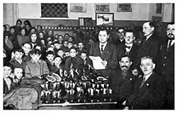 Distribution of shoes and clothing for needy children purchased the financial help of the New York Landsmanshaft organization. 1922