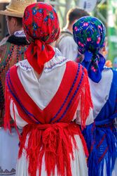 Close up of the back of Romanian folk costume for women, with multi colored embroidery.